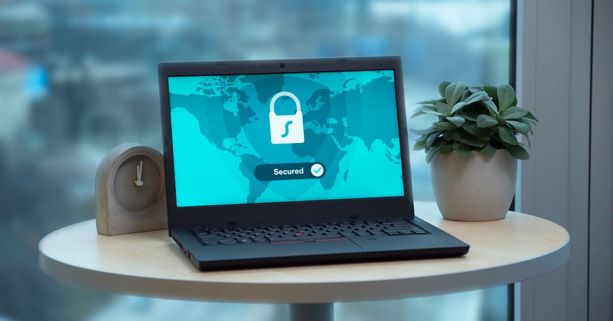 A laptop displays a padlock security icon with a green secured checkmark