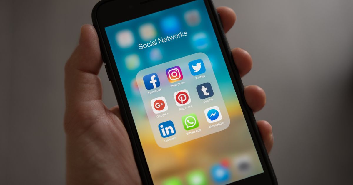 A smartphone showing an app store listing with user reviews and download count